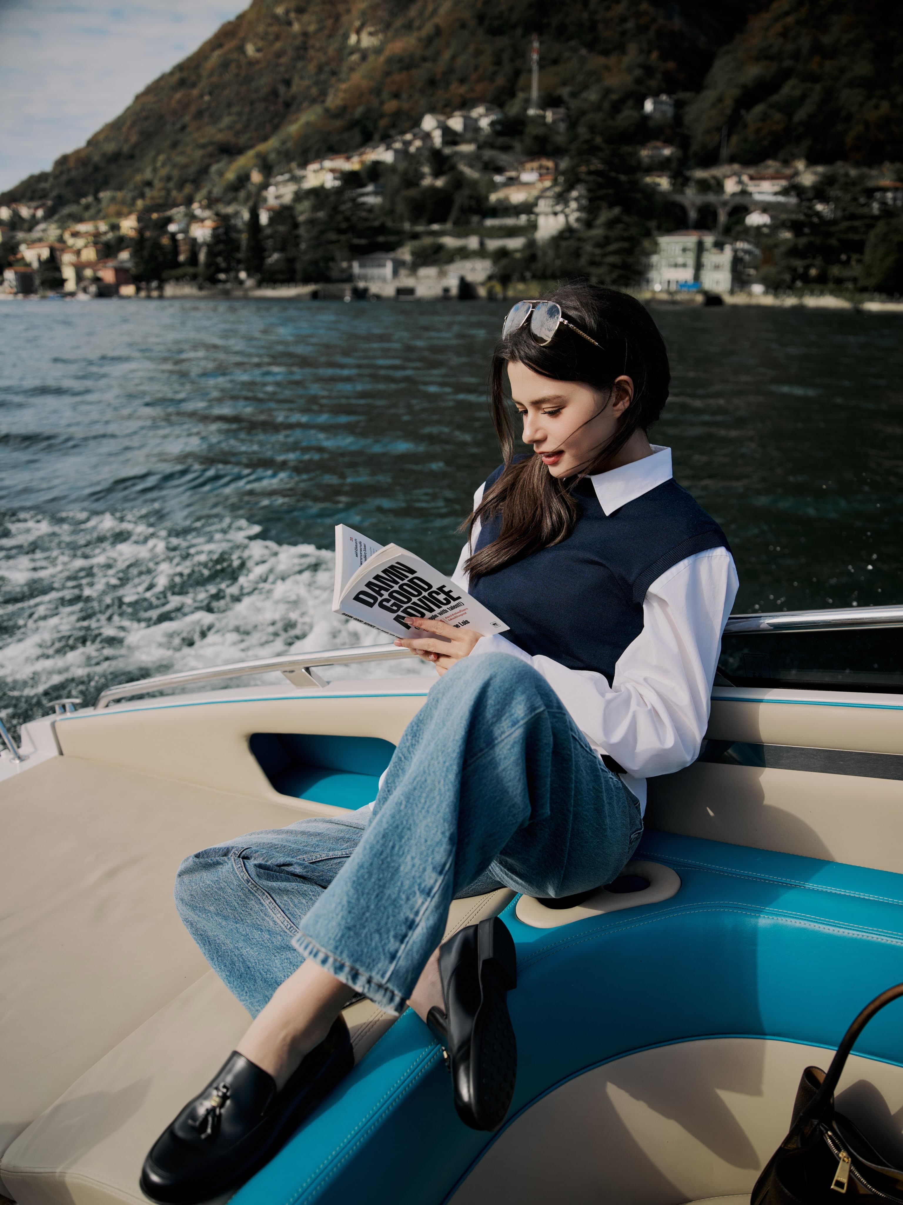 Becky Armstrong seated on a boat, with her black loafers visible