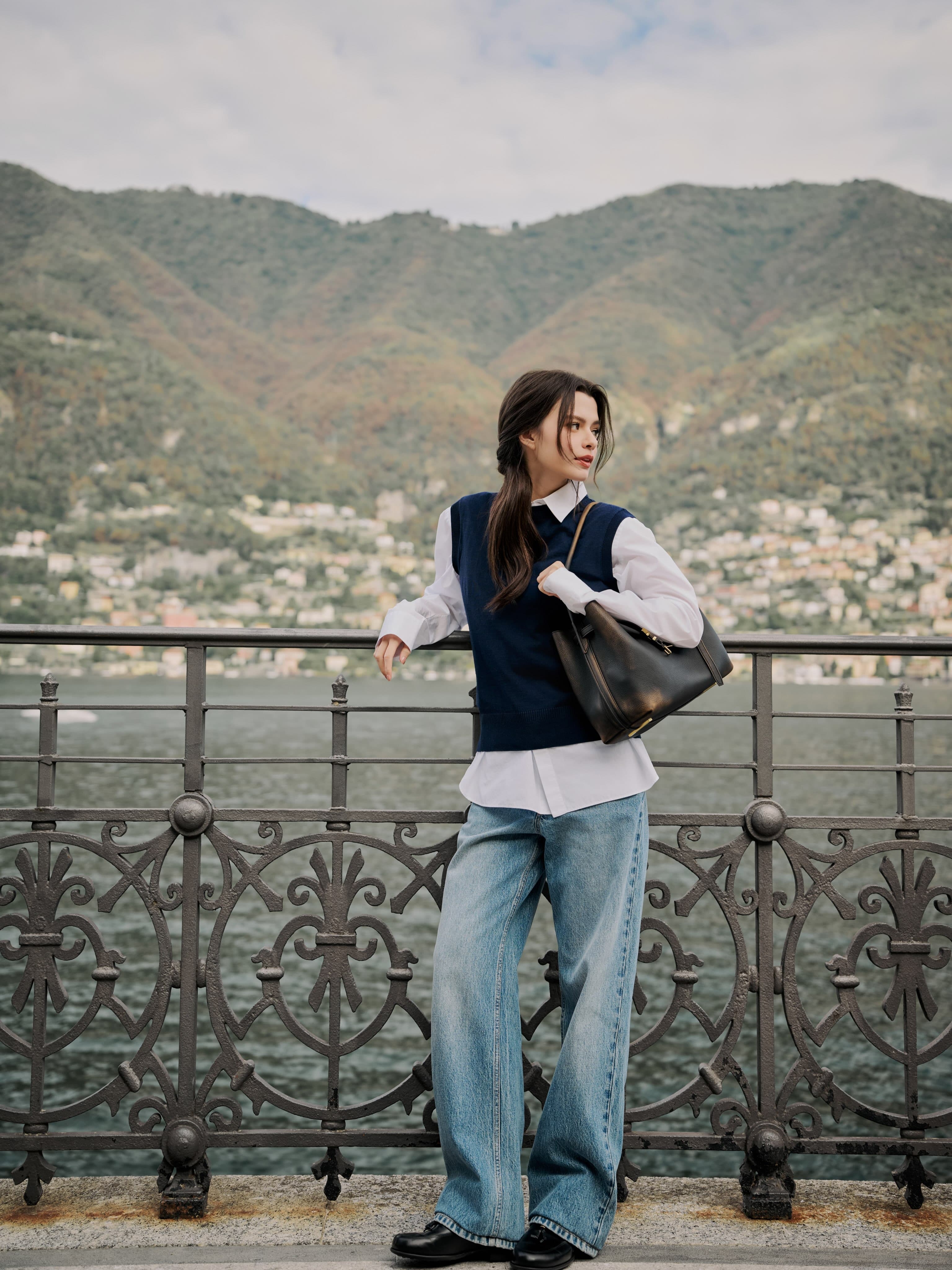 Becky Armstrong at the railing in a white shirt, loose jeans and black loafers