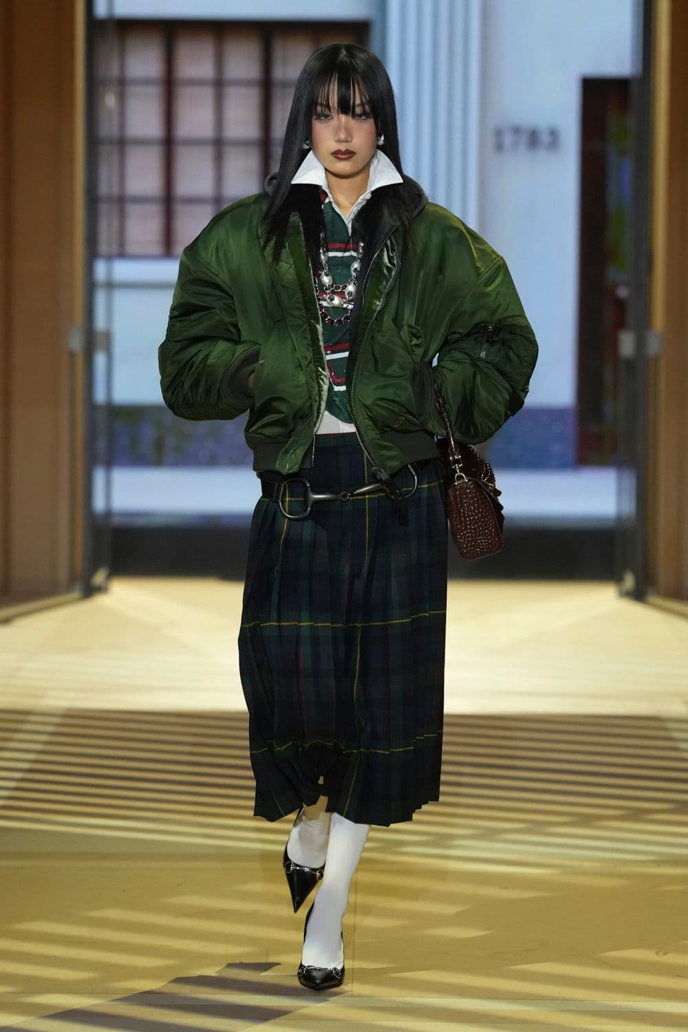 Green jacket, dark skirt and white socks from Gucci The Store Show, look 31