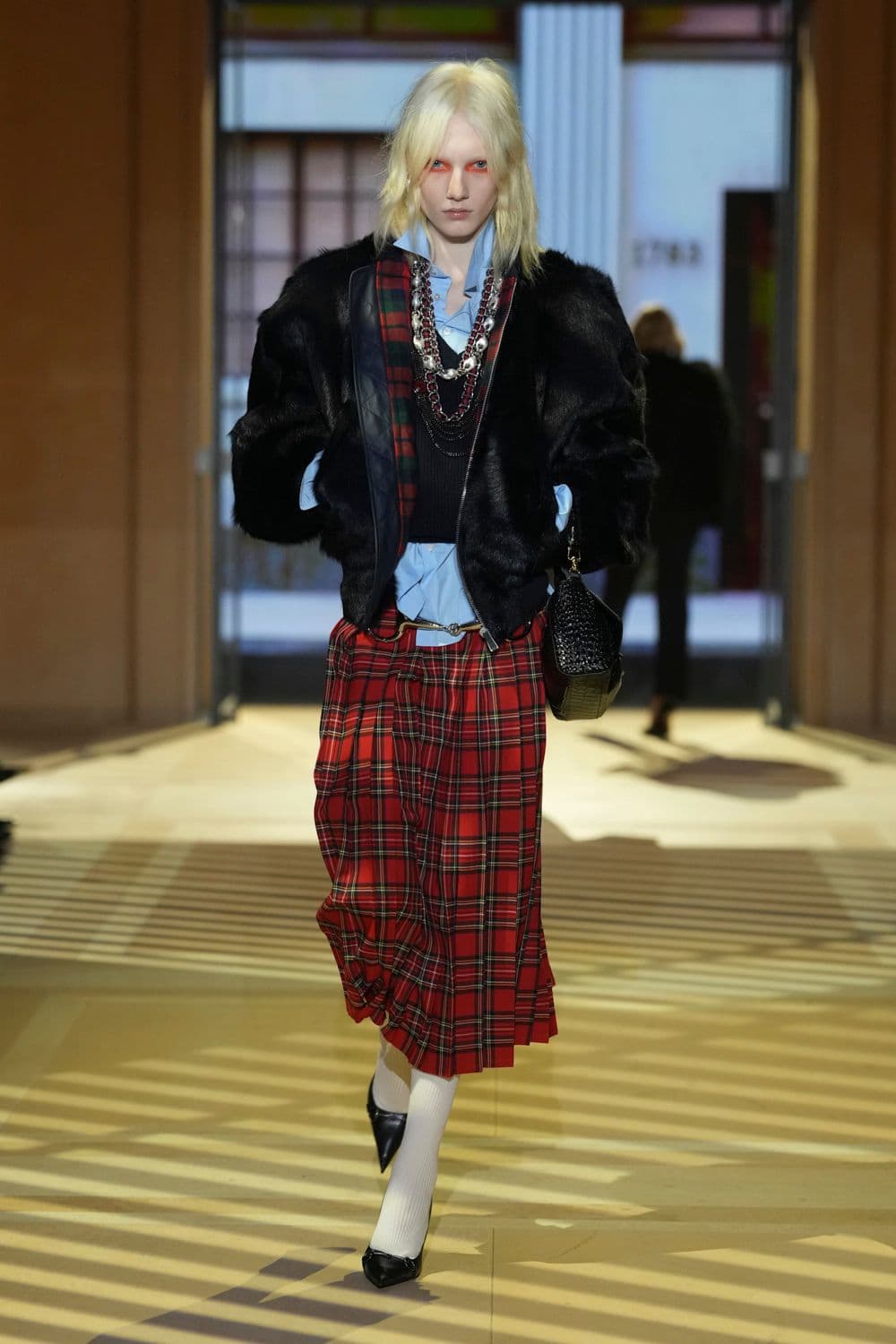 Pale shirt hem above a red tartan skirt, Gucci look 32