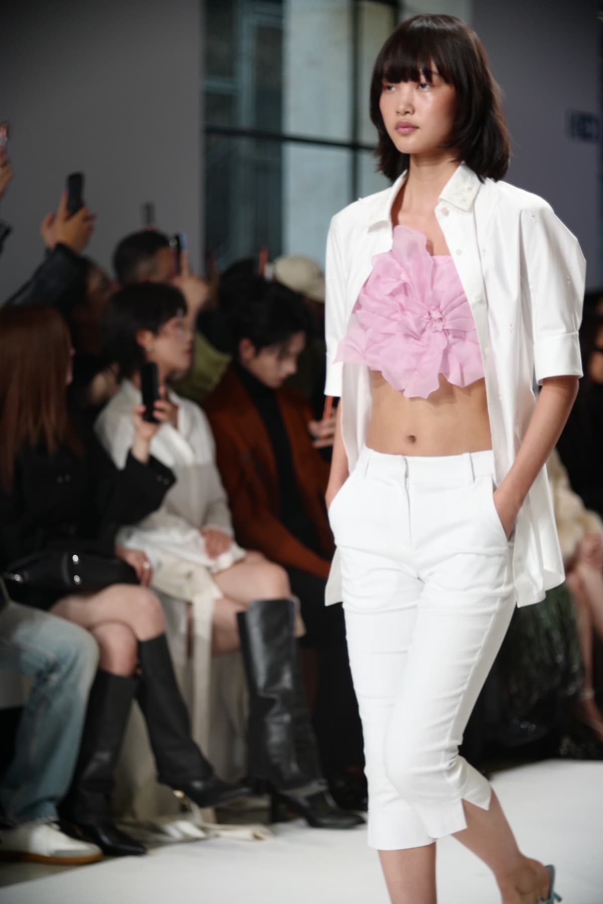 Shiatzy Chen Spring 2027: pink floral top beneath an open white shirt, with white trousers