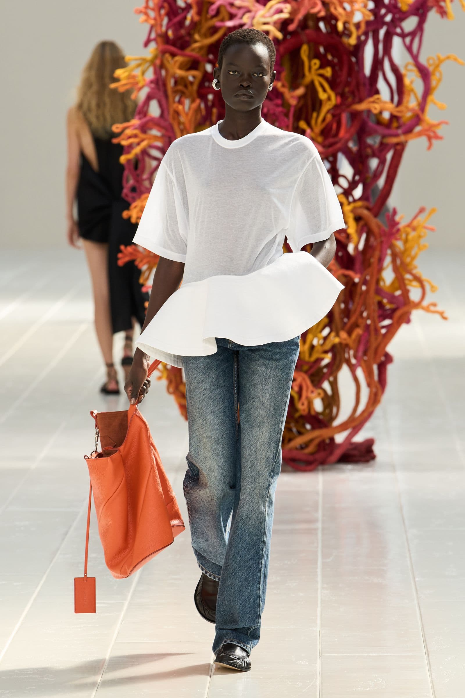 Balenciaga Spring 2027 look 35: white T-shirt with a projecting waist over jeans